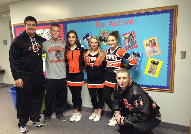Football players and cheerleaders talk about nutrition at elementary schools