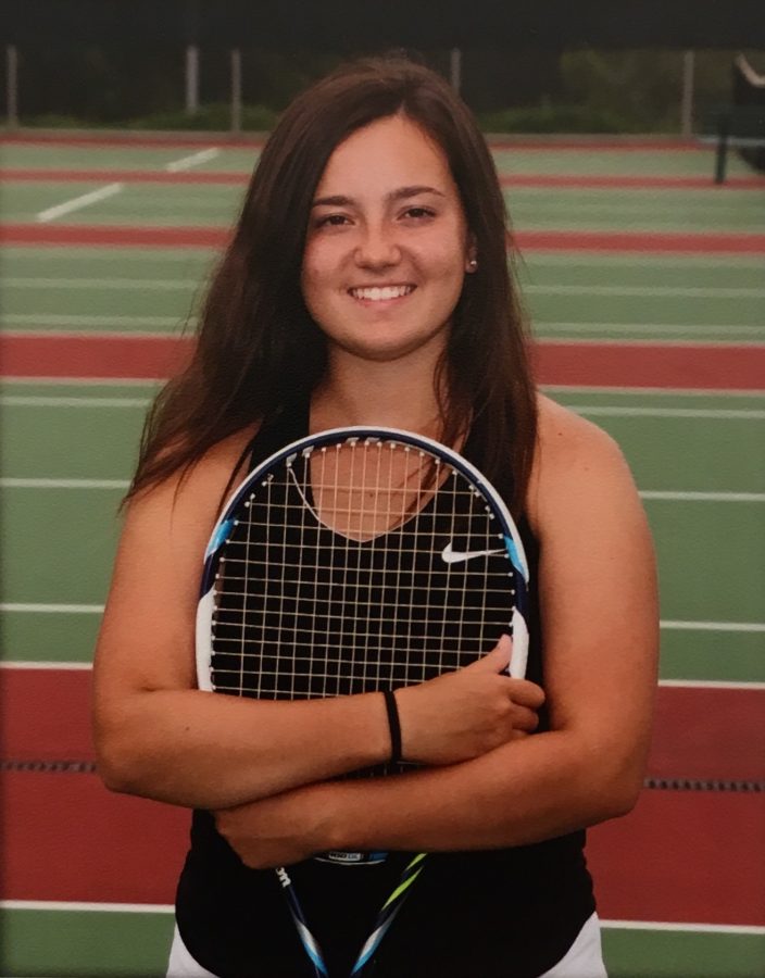 Emily Kramer poses with her tennis racket.