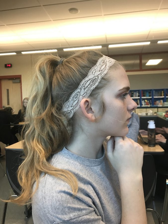 Senior Cameron Happe models her lace headband.