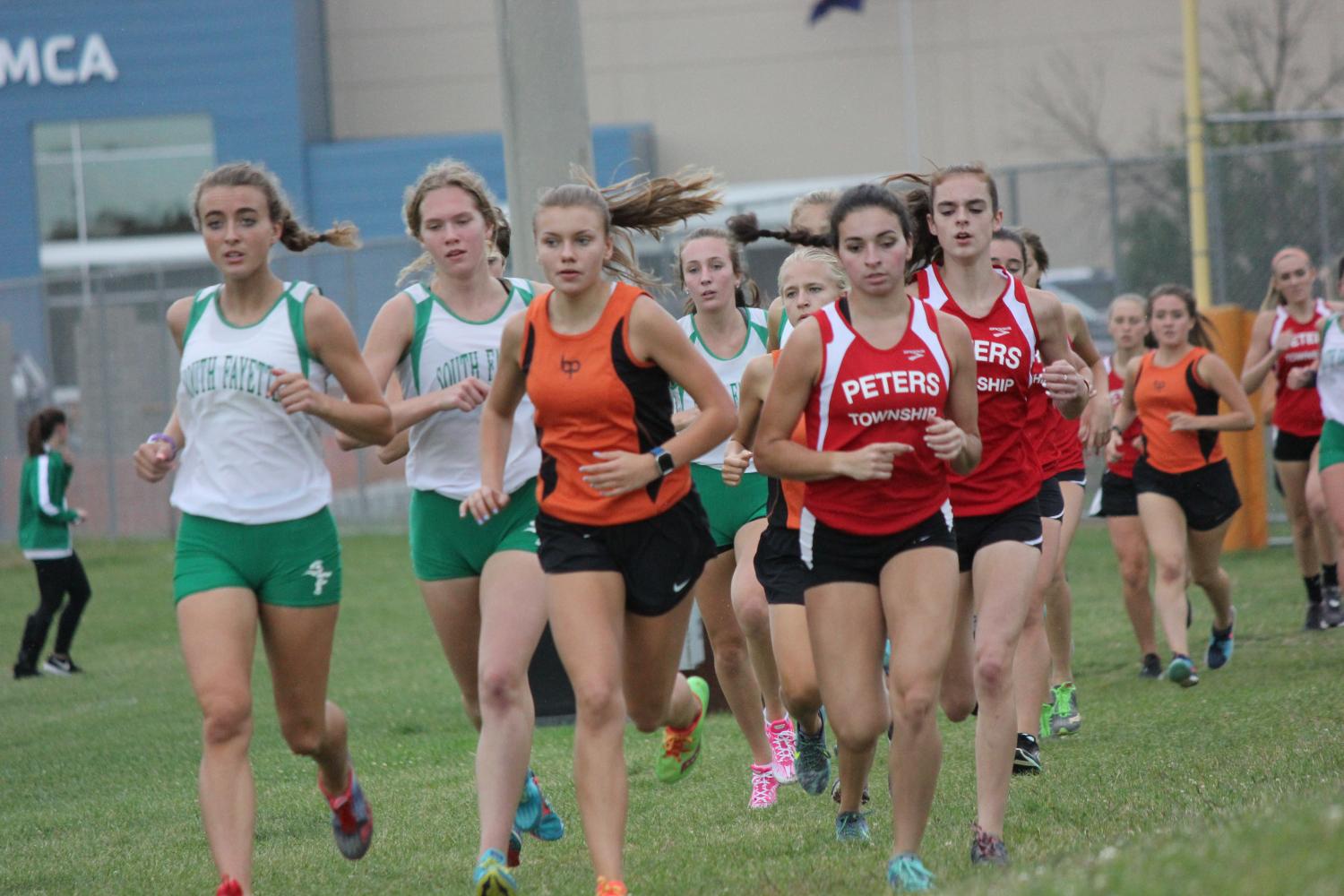 Freshman Emily Carter is neck and neck with runners from South Fayette and Peters Township on Tuesday, Sept. 12