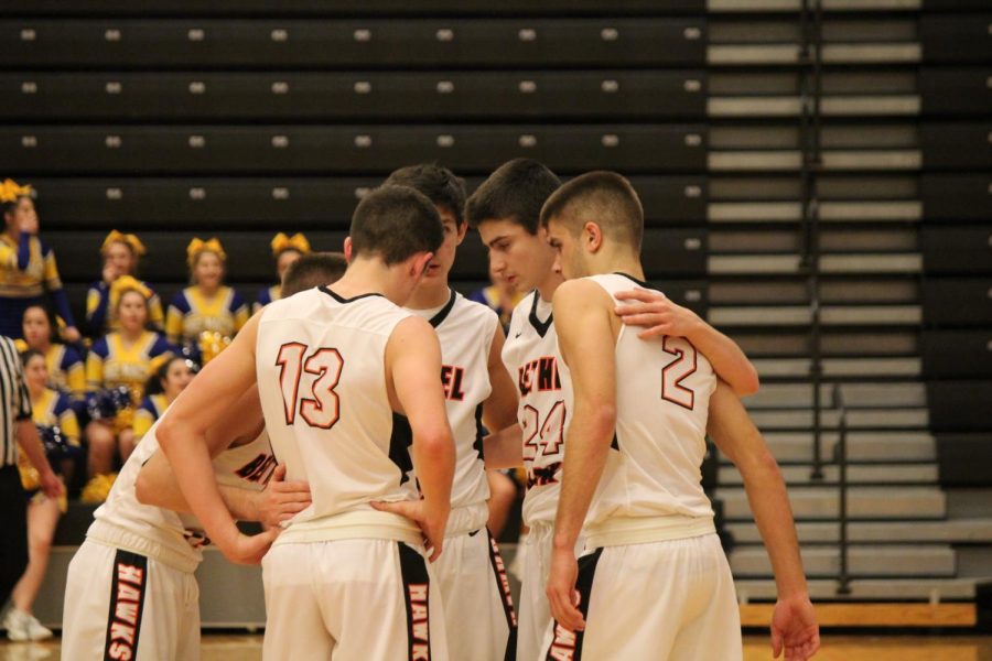 Hawks huddle up in the final moments of their game against the Big Macs on Tuesday, Jan. 30.
