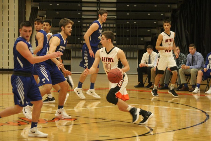 Senior Jake Nuttridge drives to the net during the boys game against Trinity on Dec. 12.