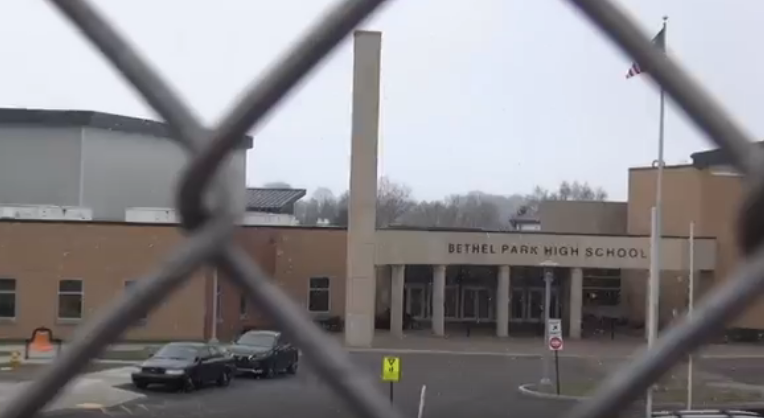 A view of the front of Bethel Park High School through the Tennis Court fence.