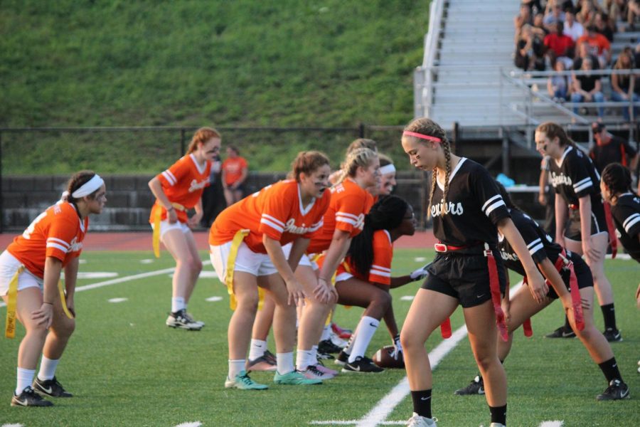 Juniors and seniors toe the line of scrimmage during their game last year. The seniors won 33-6.