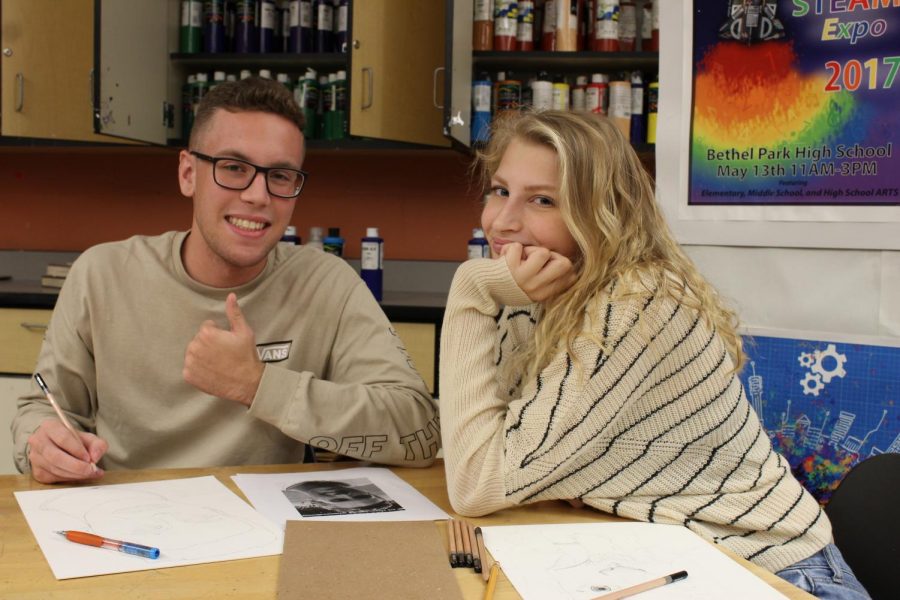 Natalie Farmerie and Tim Halpin stop and smile while working on a project.