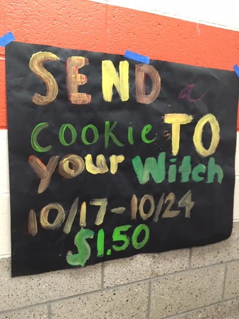 COLORFULLY PAINTED, a sign posted in the cafeteria alerts students of the Send a Cookie to your Witch fundraiser.