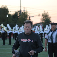 All business, Coach Metheny looks stern and in the zone before the away football game at moon.