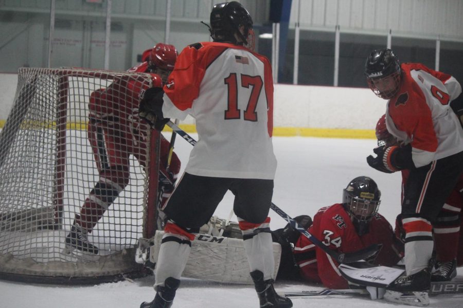 Hawks look to put the puck behind the net in their game against Peters on Dec. 6.
