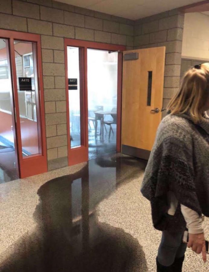 A student gets a snapshot of what happened to Mr. Piersons room on Tuesday, Jan. 22, showing what appeared to be an unknown black liquid seeping from his room.