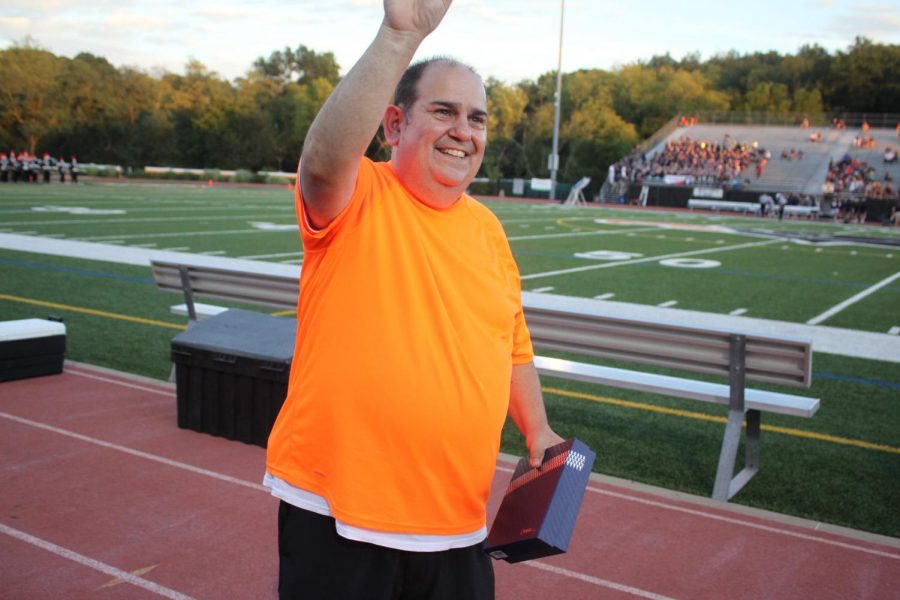 BPHS custodian Dave Caracci waves to the student section after accepting the Service Award at the Homecoming Football Game on Friday, Sept. 14, 2018.