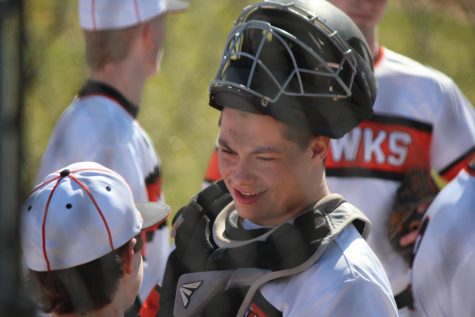 Brandon Cole lifts his catchers mask up to talk to a teammate during the Hawks Home Opener against Pine Richland on Wednesday, March 28. 