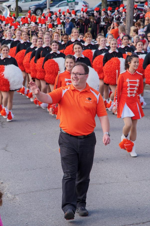 As the parade begins, director of the Bethel Park Marching Band Mr. Thompson waves kindly to the kids in attendance.