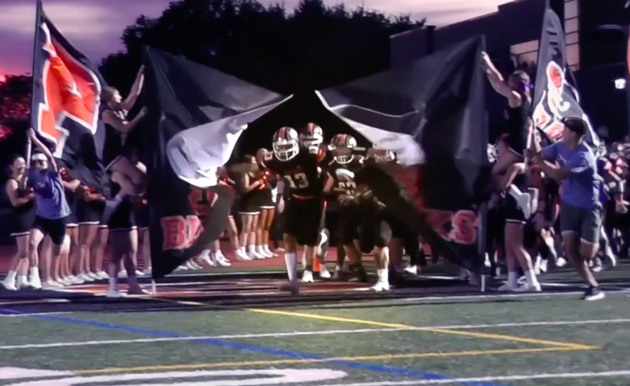 Anthony Chiccitt leads the Hawks onto the field before their game against Moon on Sept. 27.