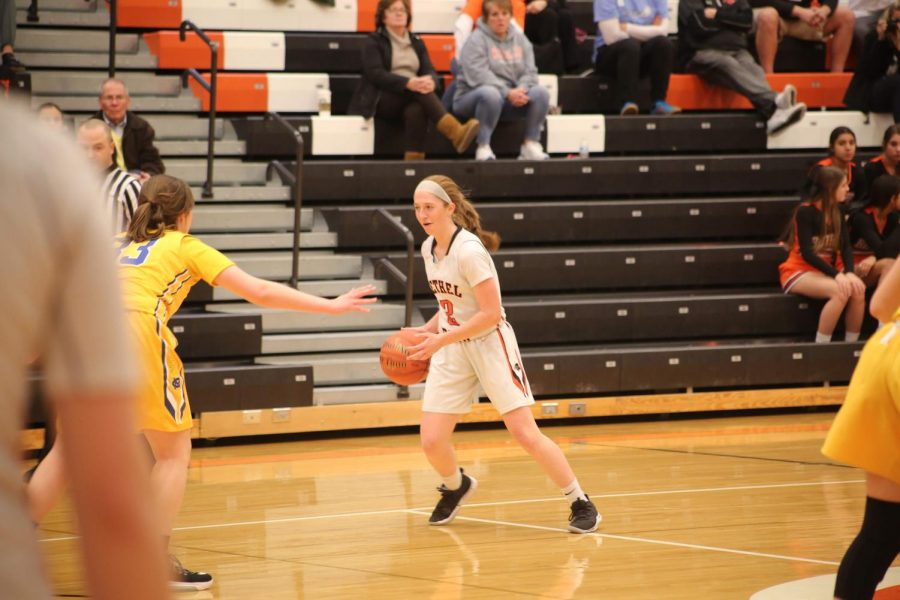 Riley Miller looks past a Canon-Mac defender for a pass during the Lady Hawks game vs. Canon-Mac on January 9.
