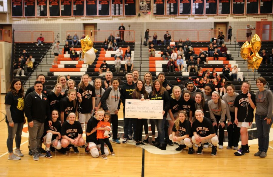 Lady Hawks present a check to the Fabus Foundation.