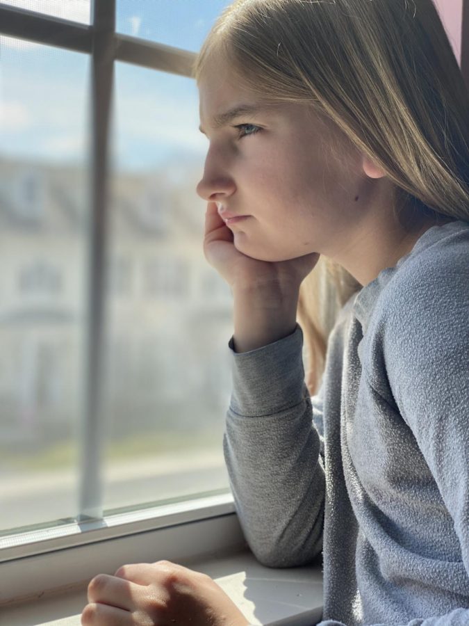 CARLISLE, Pennsylvania - Katherine Martin, 9, daughter of Army Cols. Elizabeth and Aaron Martin, looks out the window of the family’s home in Carlisle, Pa., March 15, 2020. Social distancing during the coronavirus situation can lead to a feeling of confinement