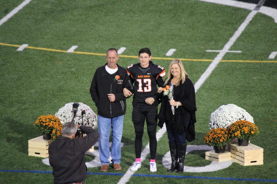 Anthony Chiccitt proudly stands with his parents on Senior Night on Oct. 18, 2019.