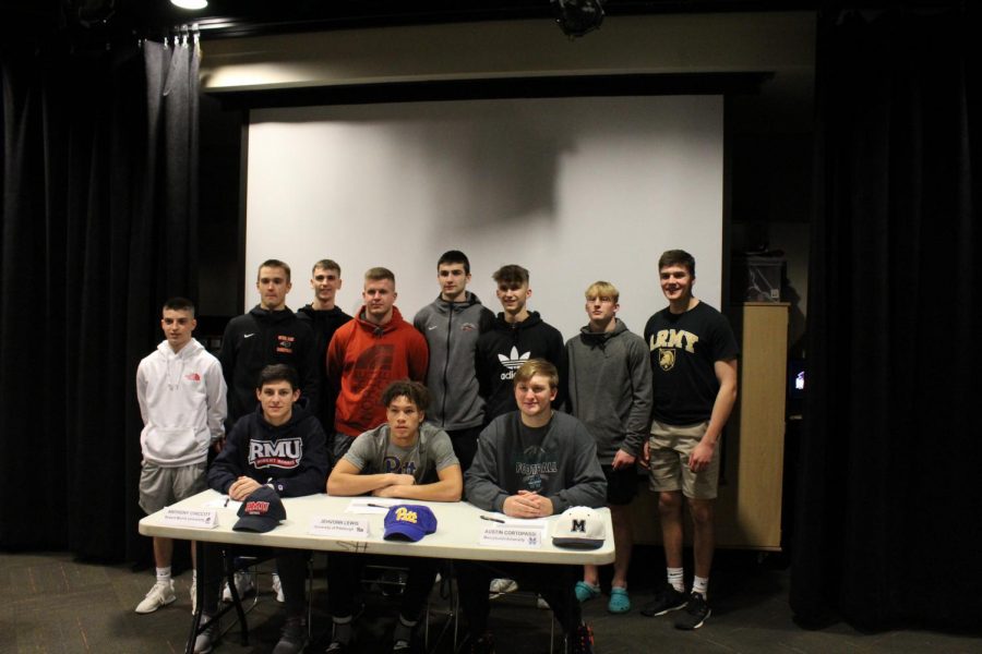 Anthony Chiccitt poses with his teammates after signing his NLI to play football at Robert Morris.