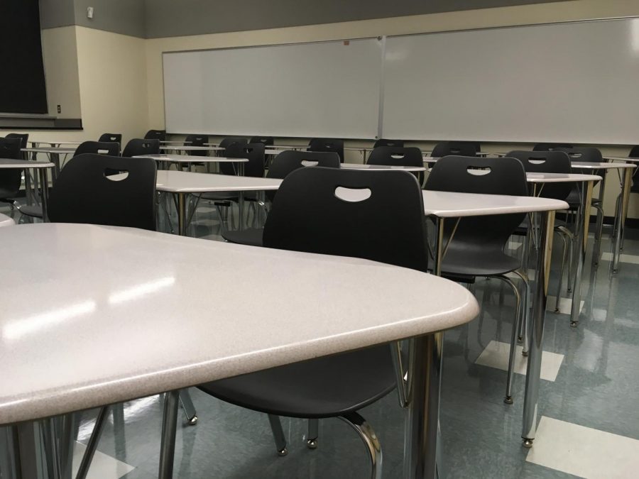 An empty classroom awaits the arrival of students.