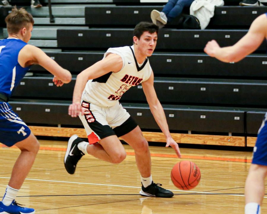 Anthony Chiccitt dribbles between two defenders during the Hawks game vs. Trinity on Dec. 10, 2019.