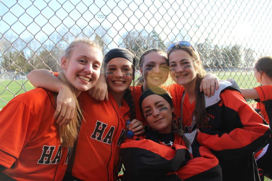 Reagan Milliken, Lauren Caye, and Delaney Nagy pose with their teammates Ali Sniegocki and Shayna Postler at their game against Peters on March 27, 2019.