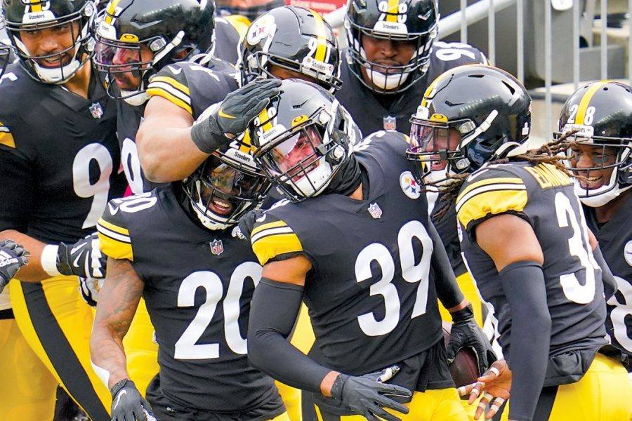 Pittsburgh Steelers free safety Minkah Fitzpatrick (39) is greeted by teammates in the end zone after intercepting a pass buy Cleveland Browns quarterback Baker Mayfield (6) and taking it in for a touchdown during the first half of an NFL football game, Sunday, Oct. 18, 2020, in Pittsburgh