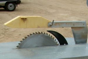 A table saw used to cut wood in a typical woodshop environment.