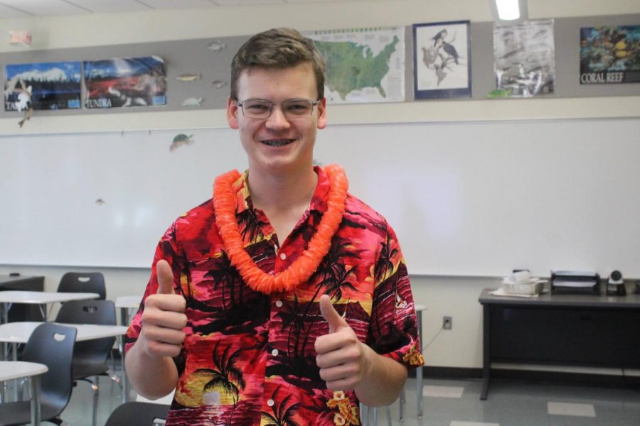 Jason Turske (junior) gives two thumbs up in his Hawaiian clothes.