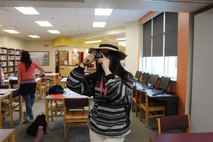 Mira Weston (junior) pretends to be a tourist as she eyes up a shot in her camera.