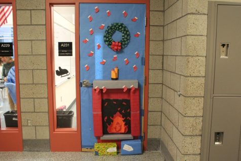 Students in Mr. Lapes homeroom decorated his door as a brick fireplace along with a wreath, stockings, and present.