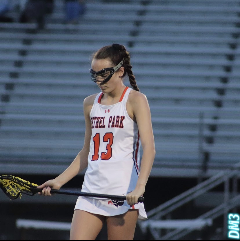 #13 Tori Krapp gets ready to take the draw on the lacrosse field.