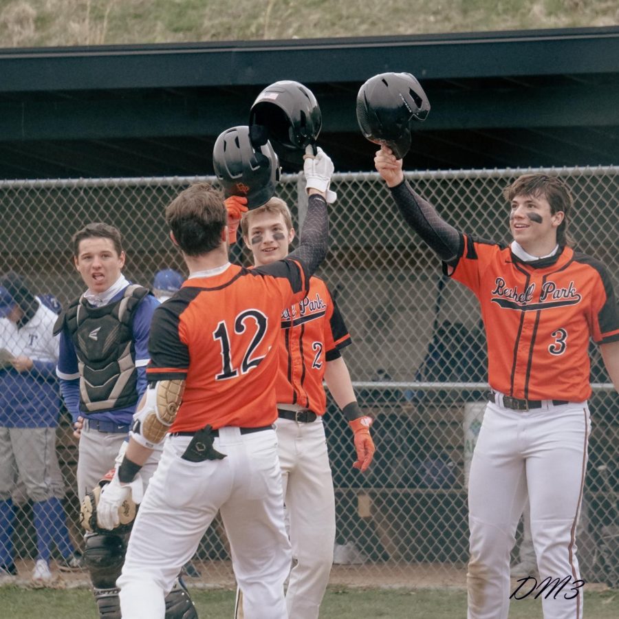 David+Kessler%2C+Jason+Nuttridge%2C+and+Cody+Geddes+celebrate+during+their+game+against+Trinity+on+Tuesday%2C+April+5.+The+Hawks+won+the+game+16-3+in+five+innings+and+improved+their+record+to+4-0.