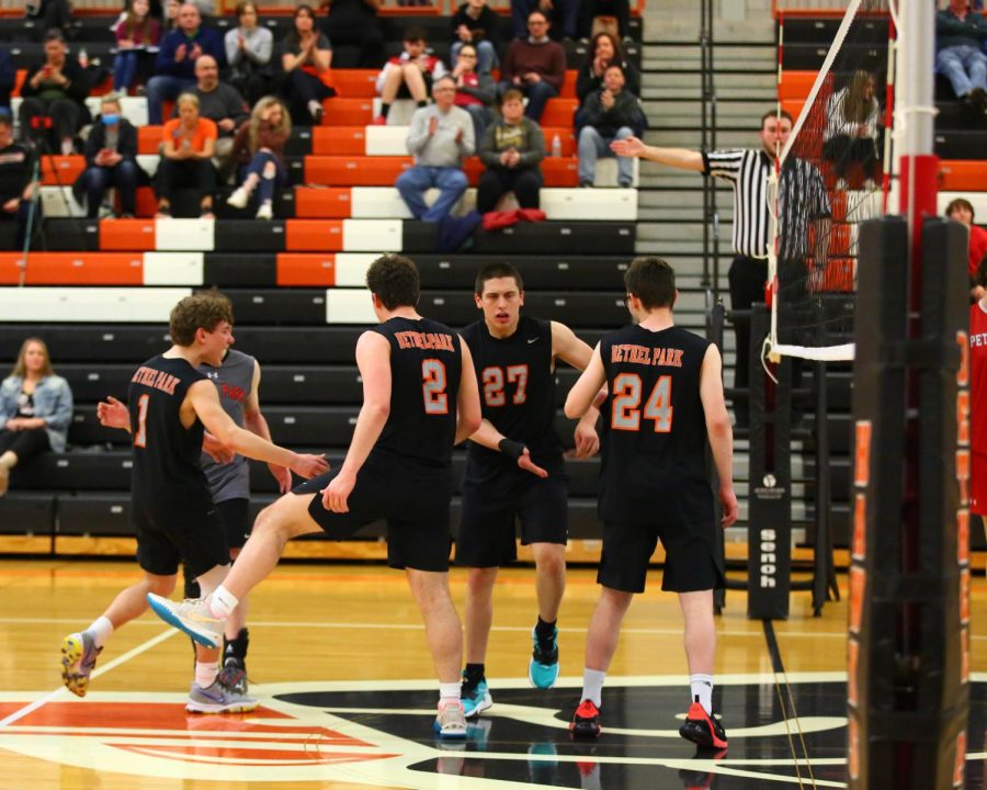 Boys+volleyball+players+celebrate+during+a+game.