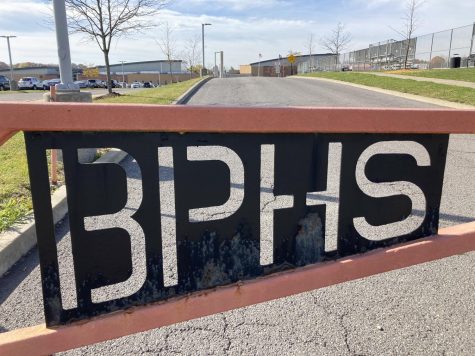 The BPHS campus is seen through the letters BPHS on the gate that marks the transition from Broad St. to Black Hawk Dr.