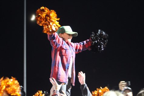 Giancarlo Gentile, donned in flannel, his late fathers signature look, enthusiastically leads the cheer at the Homecoming football game vs. Penn Hills Friday, Sept. 30. 