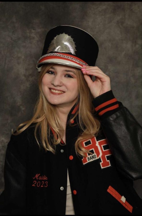 Maddie+Skaris+proudly+wears+her+marching+band+uniform+for+her+senior+picture.