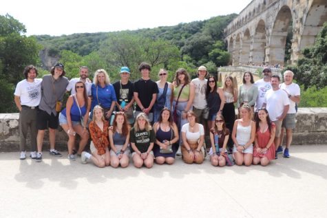 Those who attended the 2022 trip to France pose for a pic in front of the Pont du Gard, an ancient Roman aqueduct bridge.