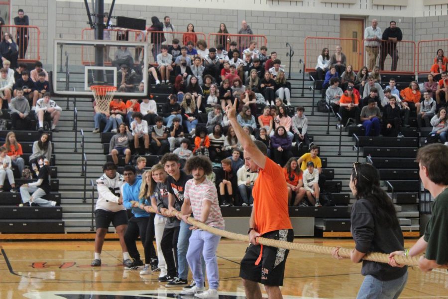 Mr. Santora blows the whistle to start the tug of war competition at the Homecoming Spirit Assembly in September.