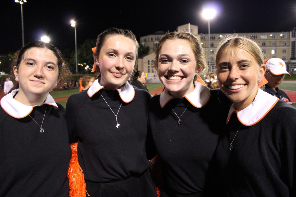 Tacey (far left) is all smiles at a Friday night football game where youll find her on the field as a Bethette.