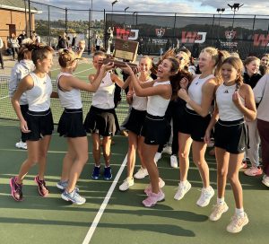 The girls varsity tennis proudly hoist their trophy in celebration of their WPIAL 3A team championship, the first in school history.

Photo credit: James Cromie
