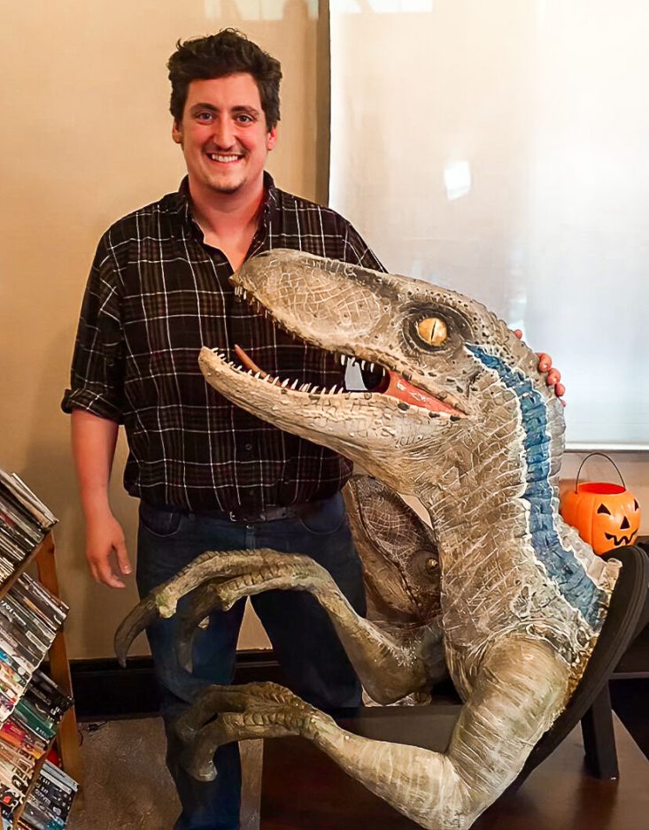 Dominic Bianco poses with a life-size bust of Blue, the female velociraptor from Jurassic World. Bianco's Jurassic Alcove will open on Oct. 5 at Fairgrounds Building 8 in South Park and will feature authentic life-size replicas of dinosaurs.

Photo courtesy of Dominic Bianco.