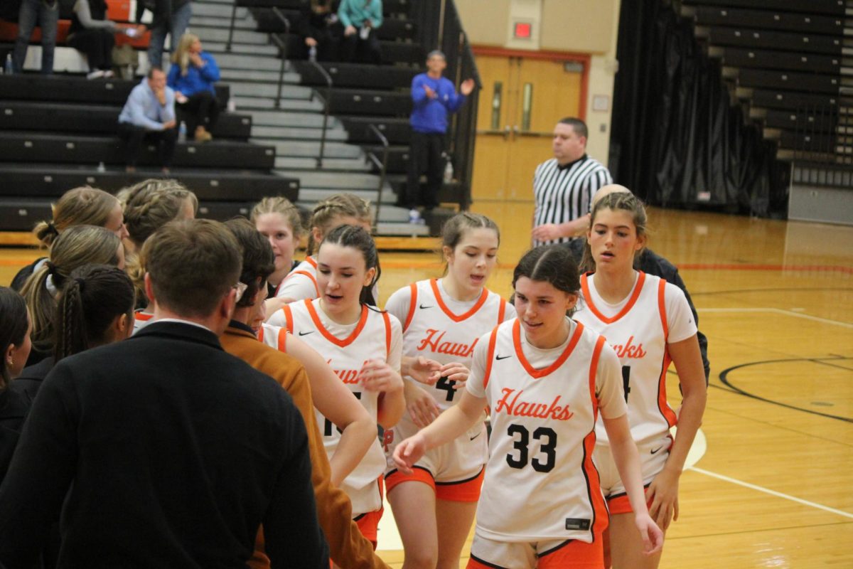 The Lady Hawks congratulate each other after their come-from-behind victory against section-foe Trinity on Thursday.