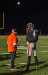 Tanner Pfeuffer listens to Coach Peckich during a game. 