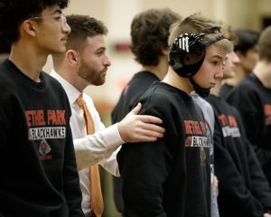 Coach Ryan "Goose" Gossett encourages 121-pound sophomore standout Pierce Reinhart before the Hawks' match vs. Baldwin on Jan. 15. The Hawks have their eyes on the WPIAL team playoffs beginning Wednesday, Jan. 29.

Photo credit: M&M Photography