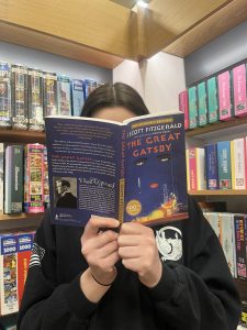 Her face in the book! Alexandra Thunborg is deeply immersed in her reading of "The Great Gatsby."