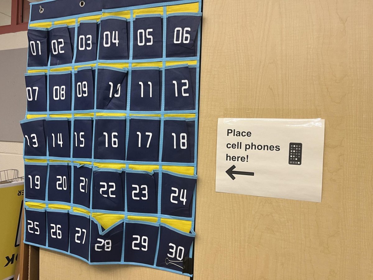 With the new personal device policy, students at the high school are expected to place their phones in assigned spots in each classroom's sleeve during class time.