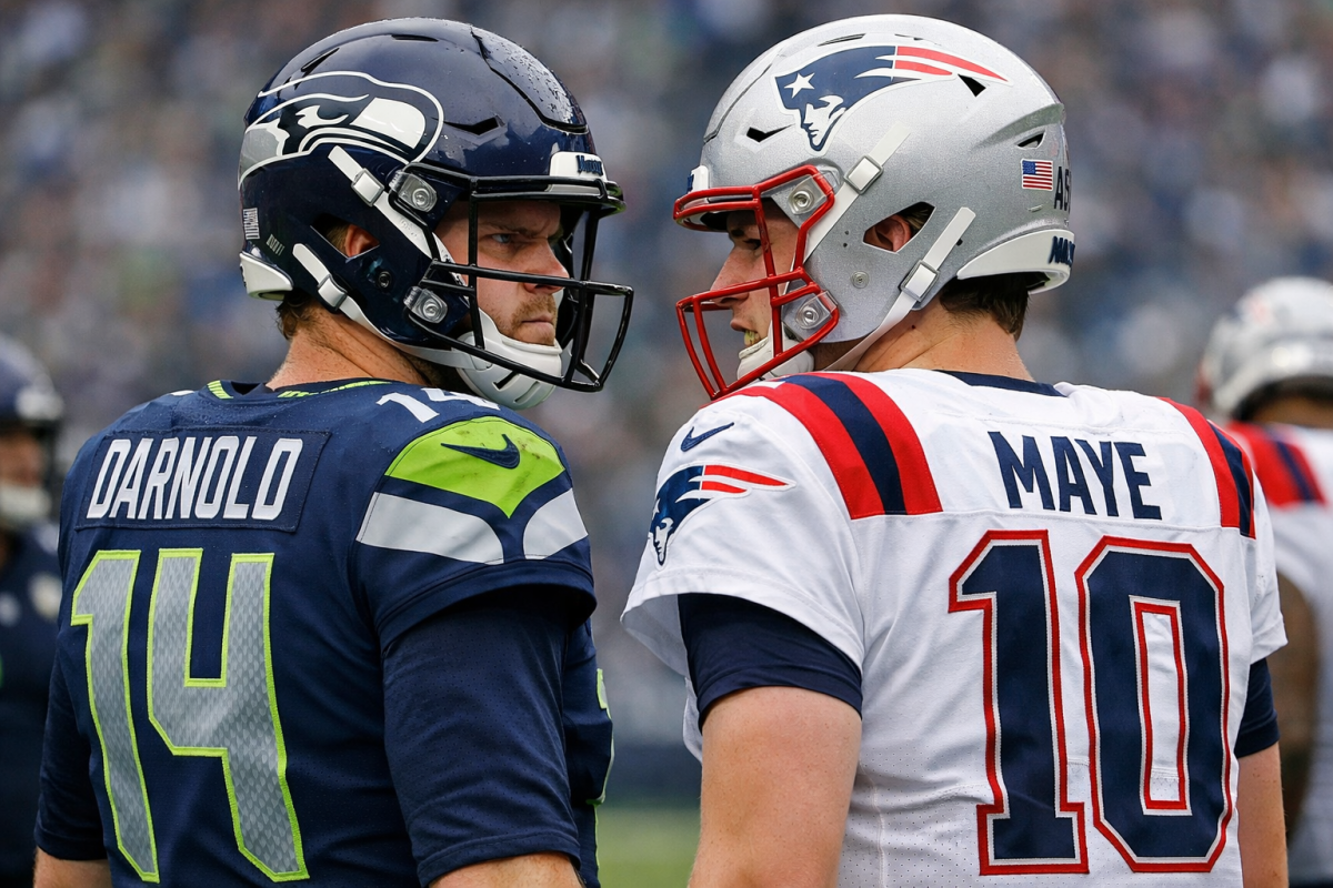 Seattle Seahawks quarterback Sam Darnold staring down New England Patriots quarterback Drake Maye on a football field (AI Generated)